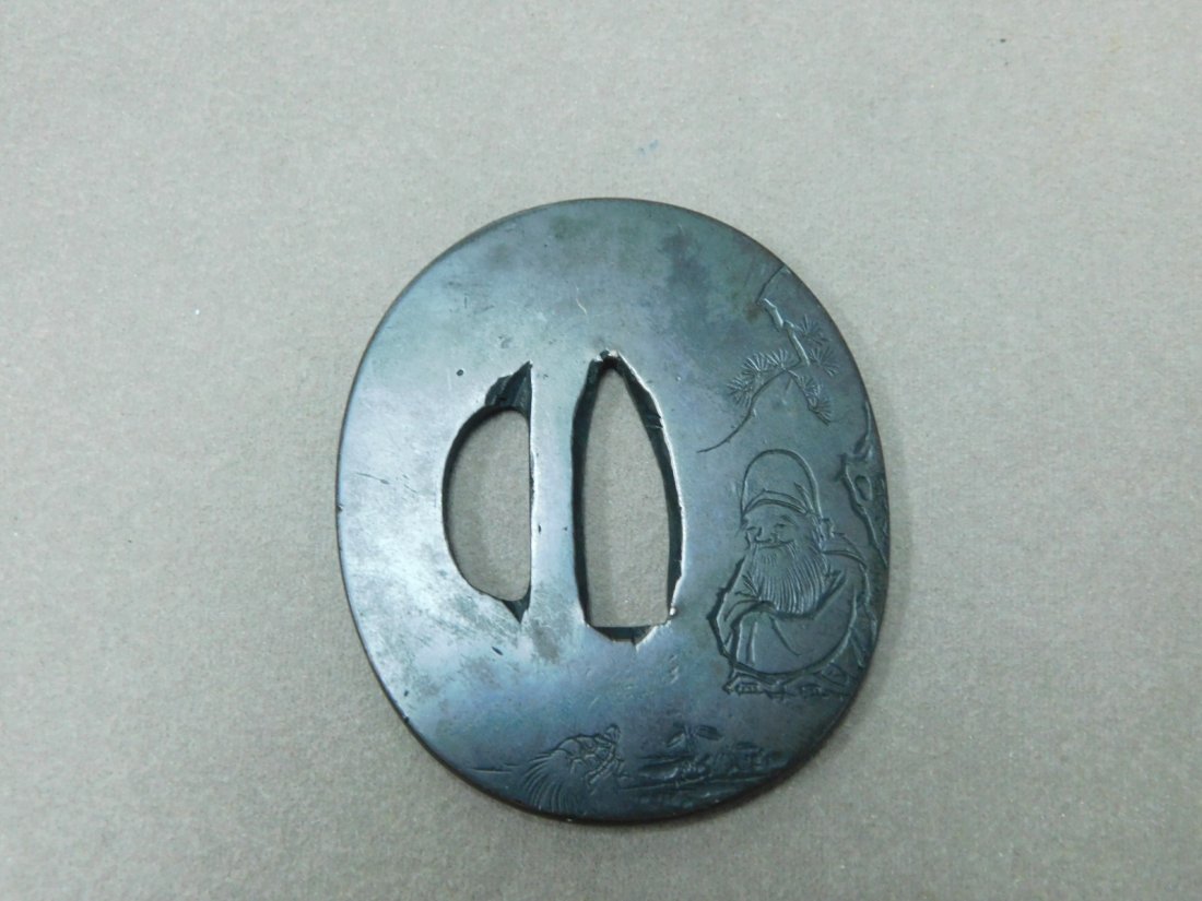 Japanese Tsuba: Japanese Tsuba, 18th / 19th C, bell brass, signed; etched seated Buddha in garden setting with turtle, verso with tree and signature, 2 3/8" x 2 1/16". CONDITION: Very good, tarnished.