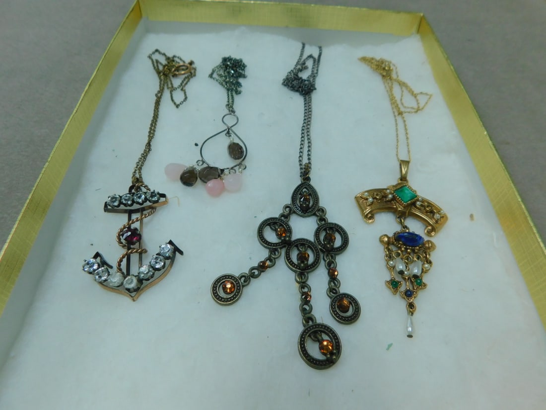 4 Costume Necklaces: 4 Costume Necklaces includes: gold filled anchor drop with cut clear and red crystal (L 1 3/4") on a 16" chain; a Victorian style gold plated pendant drop by "Art" with faux pearls, green and blue sto
