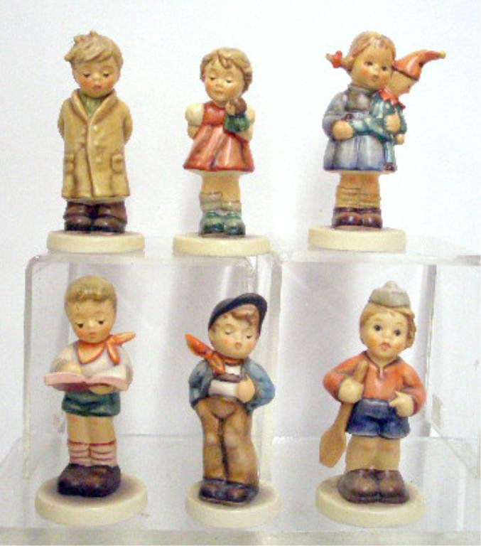 Six Hummel Figurines: Lot of six Hummel figurines, 3 1/2" #536 3/0 Christmas Surprise (TMK-7), 3 5/8" #560 Lucky Fellow (TMK-7), 4" #845 Too Shy To Sing (TMK-8), 3 5/8" #2087/B Honor Student (TMK-8), 3 5/8" #2013/A Puppet