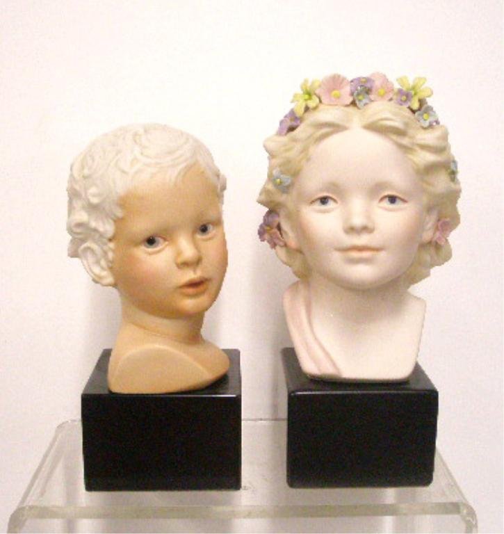 Cybis Eros & Robin Busts: Cybis porcelain 6 1/2" x 4" #477 Eros & 7 1/2" X 3 1/4" #4056 Robin bust figurines mounted on wood bases, overall sizes are 9" x 4" & 10" x 3 1/4". CONDITION: Both are very good with no damage.
