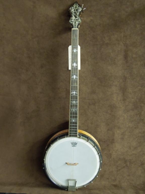 Weymann & Sons Vintage 4-String Banjo: Weymann & Sons vintage 4-string open back banjo with Remo head. Mother of pearl inlay on headstock & fretboard, serial # 33303. CONDITION: Good, showing wear, some finish loss & scratches.