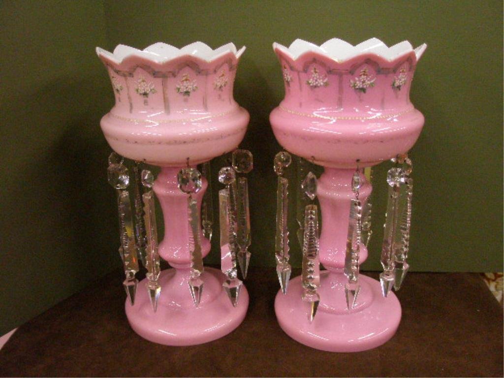19th c. Cased Glass Lustres: Pair of c. 1880 cased glass 13" lustre, pink glass with white casing, arched floral urn enameling, cut spear prisms. CONDITION: Areas with gilt & paint loss on both, chipped prisms on both.