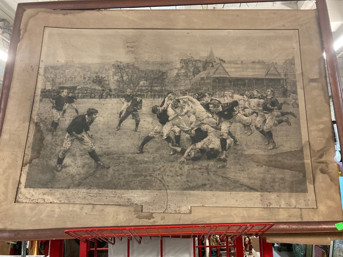 19th C. Rugby Engraving: 19th C. Rugby Engraving, game action scene with 27 1/2" x 37 3/4" frame, no glass. Condition: frame dirty, engraving stained and areas of spotting, matte rough on edge.
