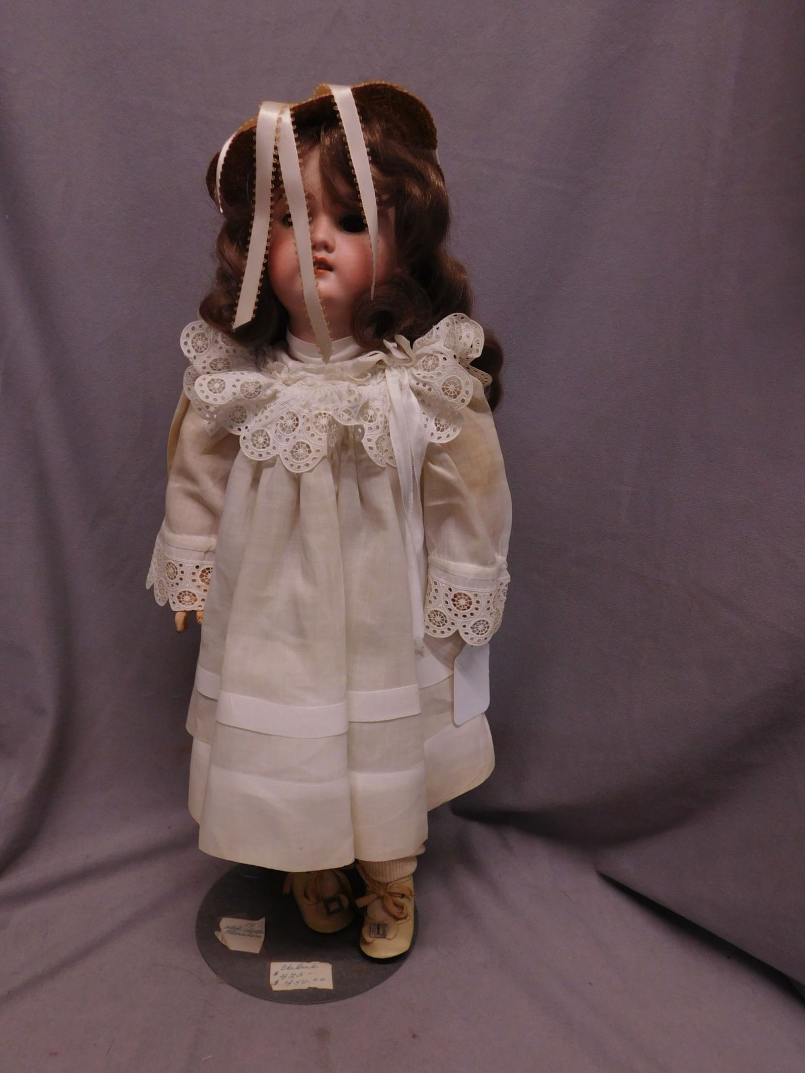 A & M Floradora Doll: A & M Floradora Doll, German, bisque head, brown sleep eyes, open mouth with teeth, brown wig, composition ball jointed body, linen and lace work dress and under garments, 19"h. [8] CONDITION: Very go
