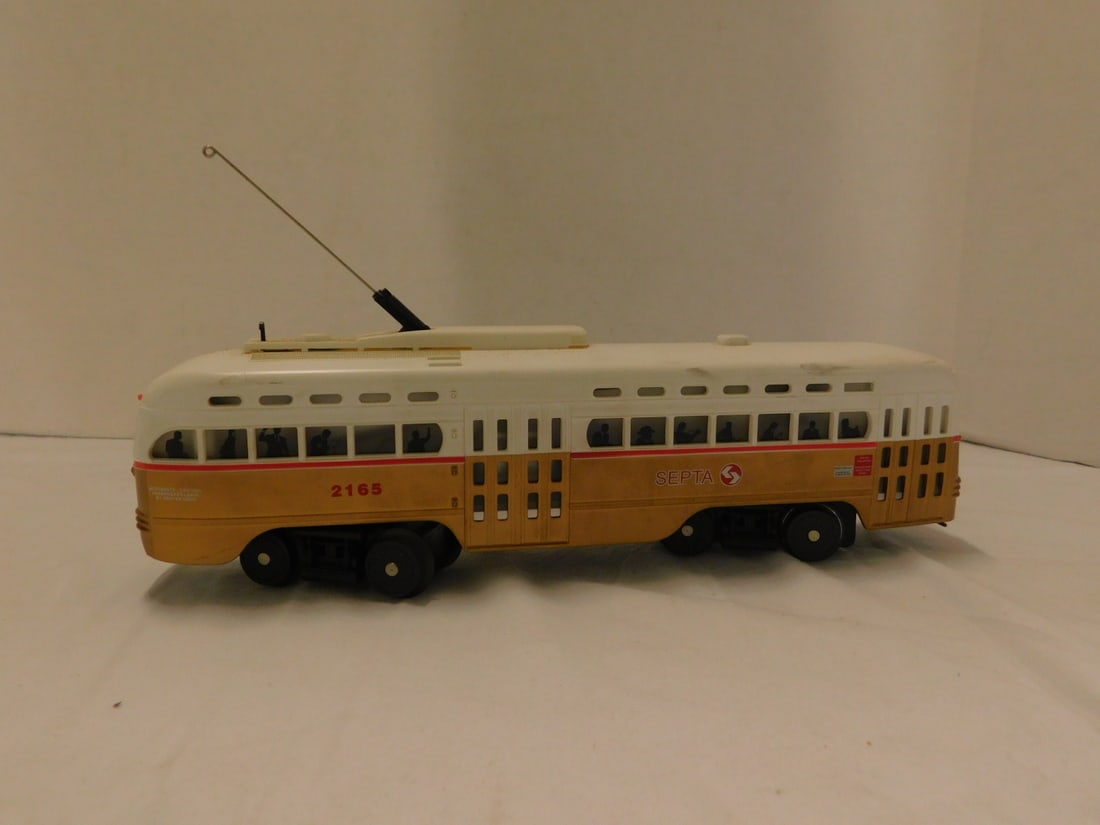 Rail King MTH O-27 Gauge Septa Trolley: Rail King MTH O-27 Gauge Septa Trolley, loose, no box #2168, gold base, white top, lighted car, 11 1/2"l, untested. CONDITION: Very good, very minor exterior wear.