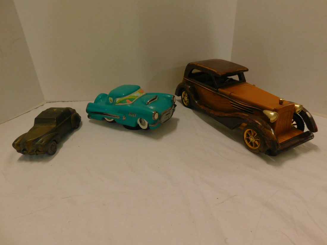 3 Novelty Car Form Collectibles: Three Novelty Car Form Collectibles, including: Wood antique car form box (box opens at front hood), 14 1/2", porcelain Thunderbird form music box (wind up disc under car), 8 3/4", plus metal car bank