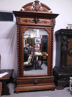 Victorian Ornate Carved Armoire: Victorian Ornate Carved Armoire, Renaissance Revival, walnut, arched and crown shield carved crest over two dimensional carved female mask and scrolls flanked by Satyr masks, full round spiral corner