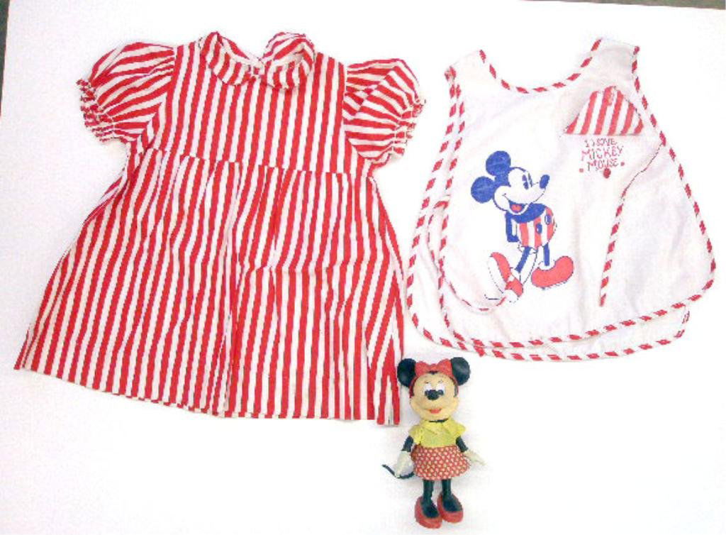 Mickey Mouse Apron & Minnie Mouse Doll: 1950's Walt Disney Mickey Mouse child's apron & dress together with 1960's Minnie Mouse 7" hard plastic doll. CONDITION: Both have minor wear.