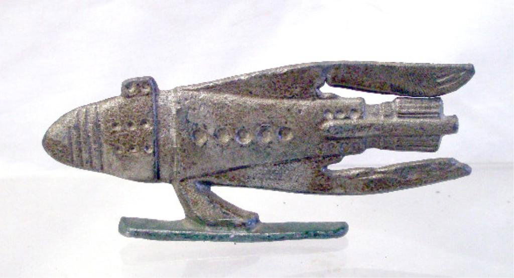 1934 Buck Rogers Cast Lead Spaceship: 1934 Rapaport Brothers, John F. Dile Co., Buck Rogers cast lead 2" x 4 1/2" spaceship from the Buck Rogers electric caster set. CONDITION: Very good with minor wear.