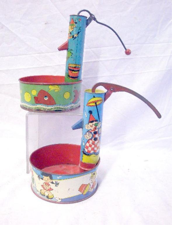 Ohio Art Water Pump Sand Toys: 1940's & 1950's Ohio Art Co. lithographed tin 8 1/2" water pump sand toys. CONDITION: Both have areas with wear, loss & or rust.