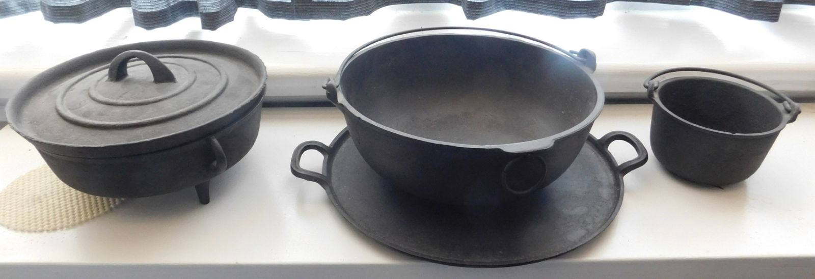 Cast Iron Pots: Cast Iron Pots including: (3) pots (one covered), plus (1) skillet, (one marked Holland, the rest unmarked), 5 1/4" - 15". Condition: very good