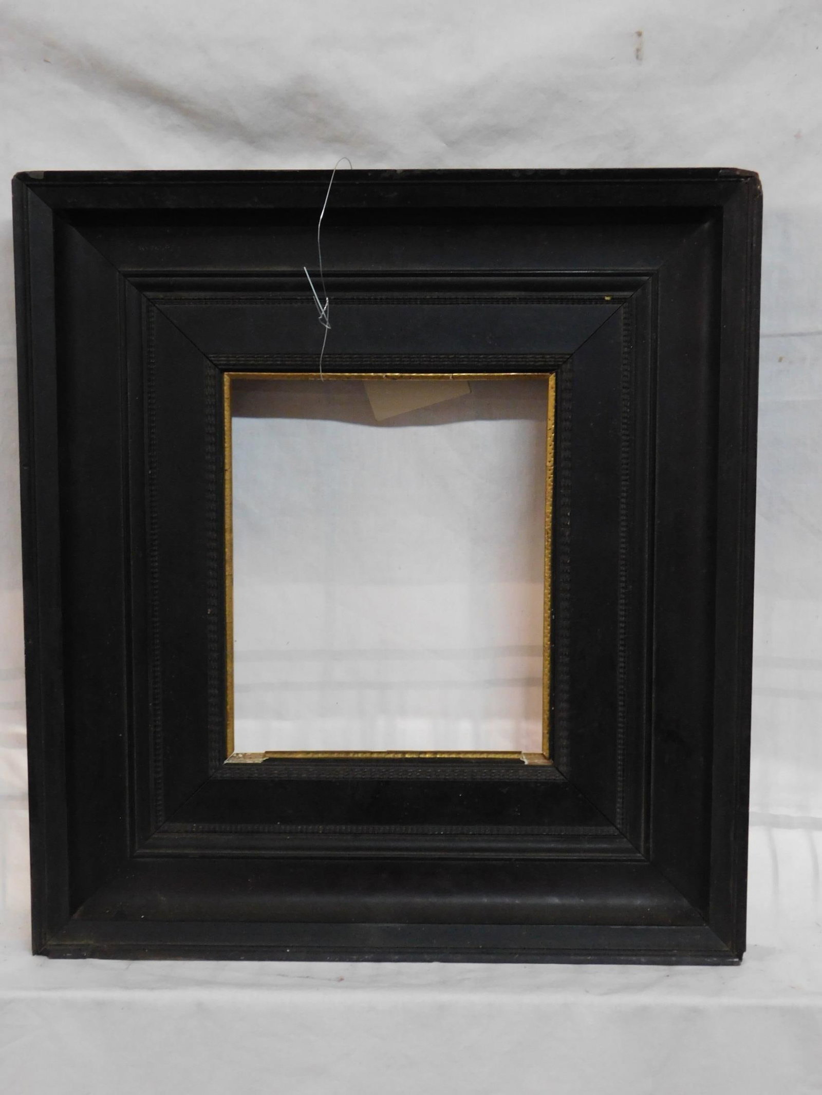 Empire Frame: Empire Frame, very dark mahogany molded wood frame with thin patterned borders, gilt and gesso inner border, 15 3/4" x 17 1/4"; inner border 7 3/4" x 9 1/4". CONDITION: Edge chips, gilt and gesso loss