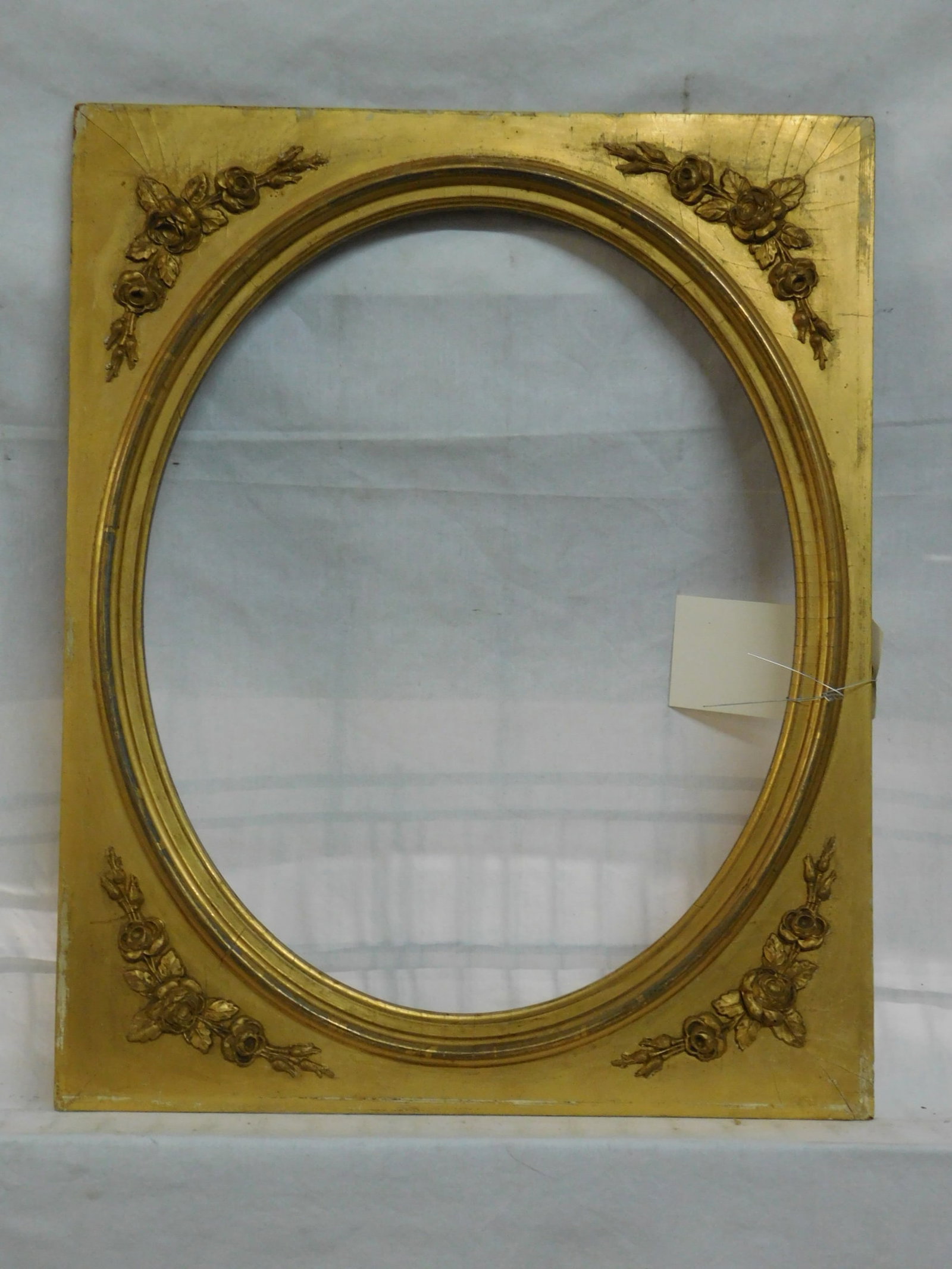 Antique Inner Frame: Antique Inner Frame 16" x 19 3/4" wood mat and oval inner frame gilt with applied molded rose sprig spandrels, oval interior 12 3/4' x 16". CONDITION: Areas of gilt wear and loss.