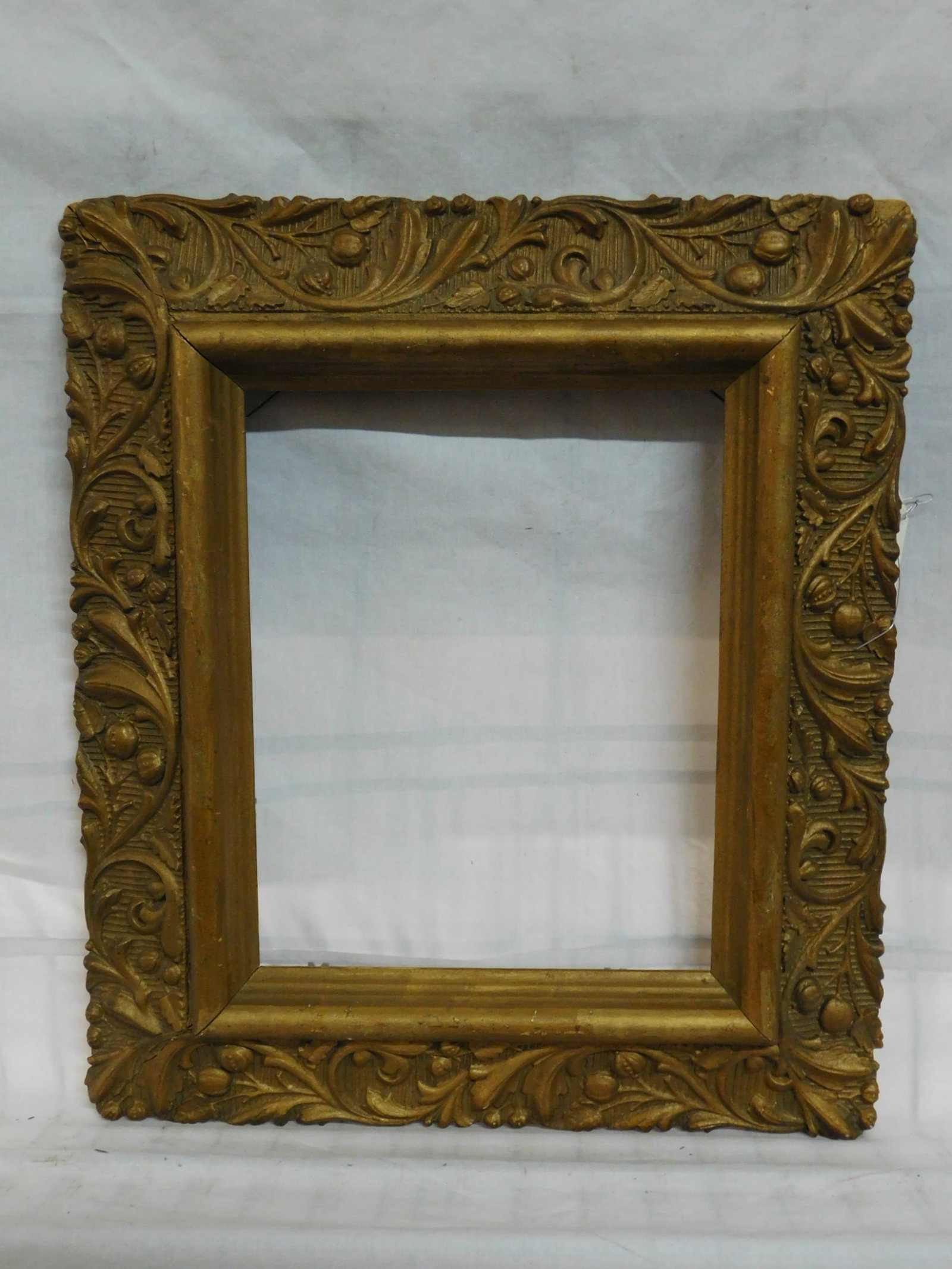 Rococo Frame: Rococo Frame, gilt on gesso over wood, relief molded acanthus and berry border, 13 1/4" x 15 1/4"; interior 8" x 10". CONDITION: Good, very slight corner chips and gold paint wear.