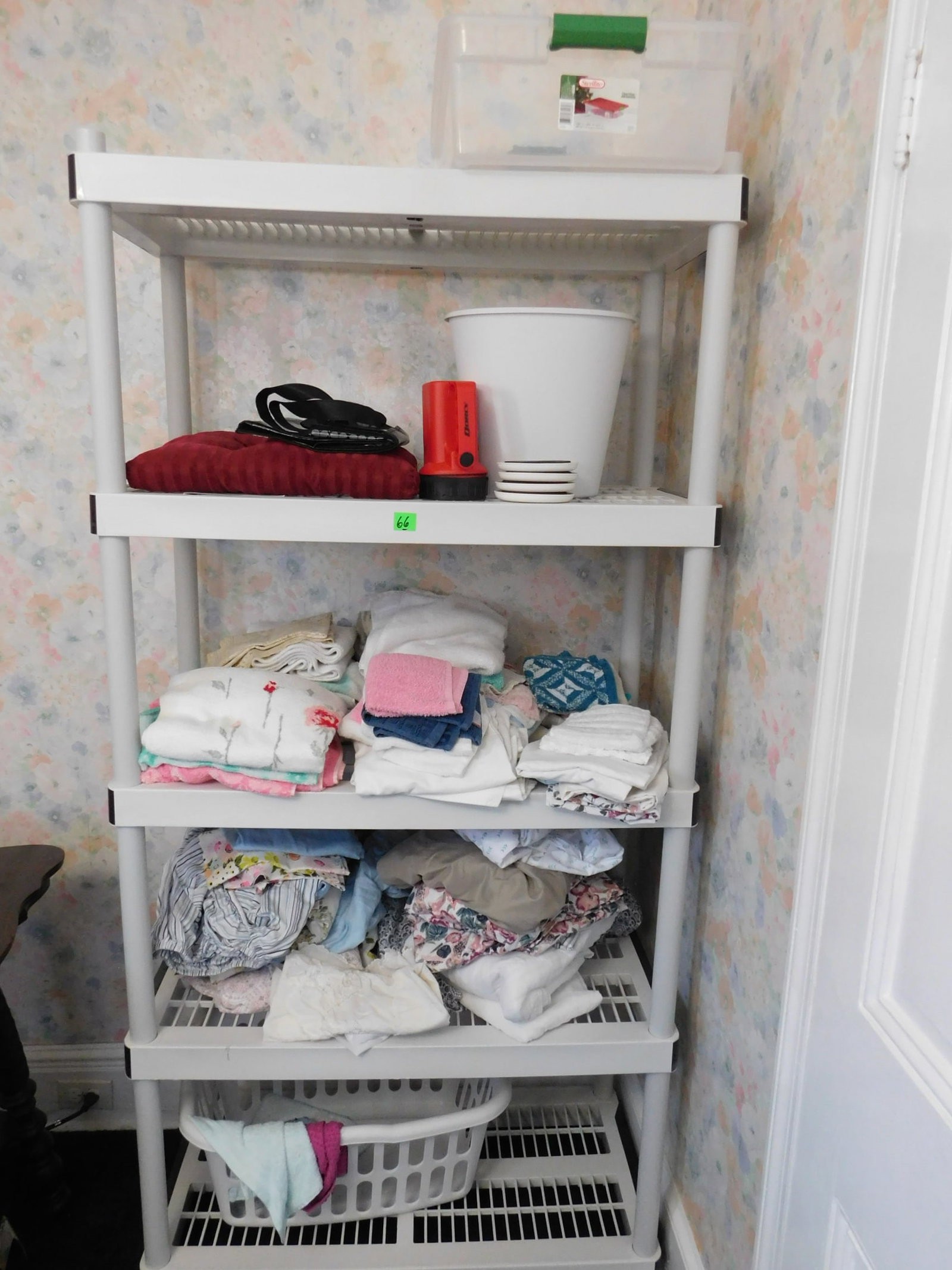 Plastic Stackable Shelf: Plastic stackable shelf, 5 shelves with towels, bed linens, etc.. Condition: good