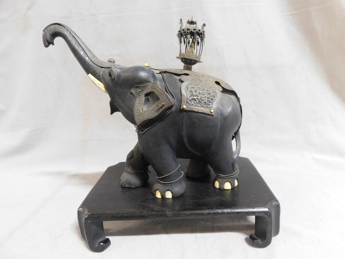 Indian Silver & Ebony Elephant: Indian Silver and Ebony Elephant, ebony wood carved with bone accents, repousse silver mounts and howdah, 19th / 20th C, 8"h, 8 1/2"l, includes: wood platform base. CONDITION: Tarnished silver, some o