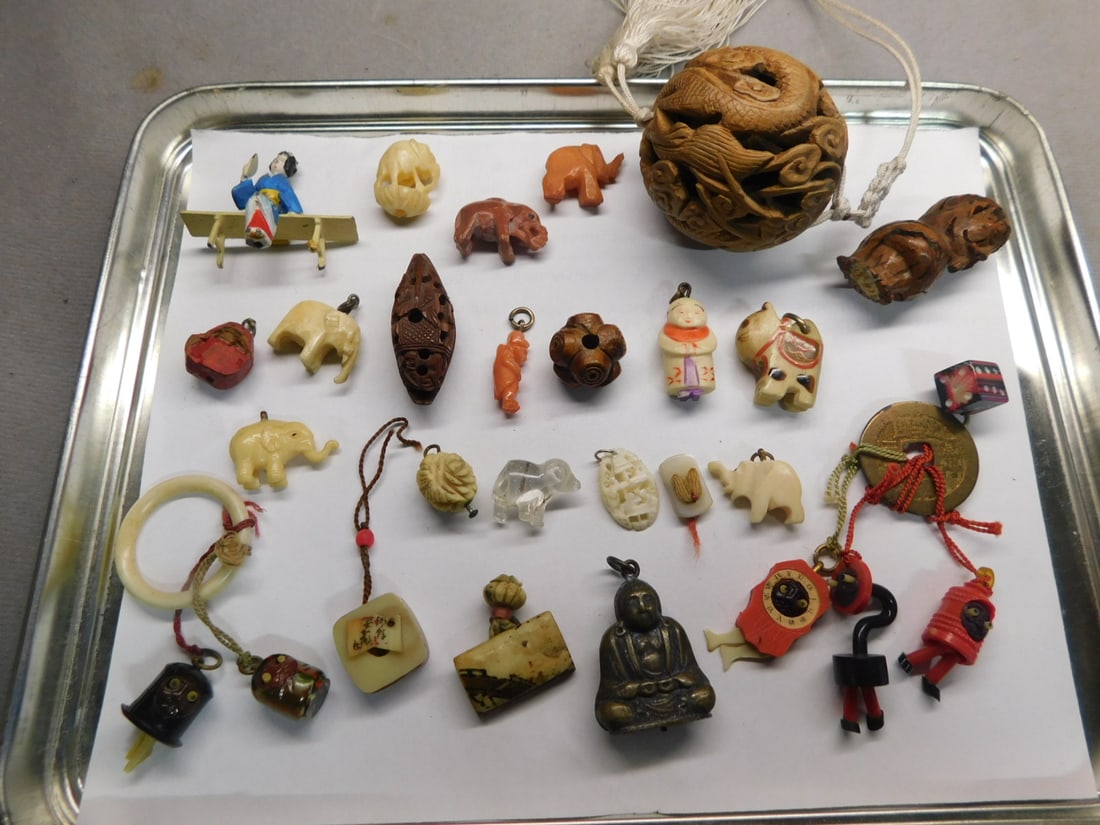 Oriental Charms Group: Oriental Charms Group, includes: silver Buddha, coral, bone, soapstone, nut, wood and bakelite of figures, animals, novelty figures, beads, etc. plus a painted die cast metal Geisha on bench. CONDITIO