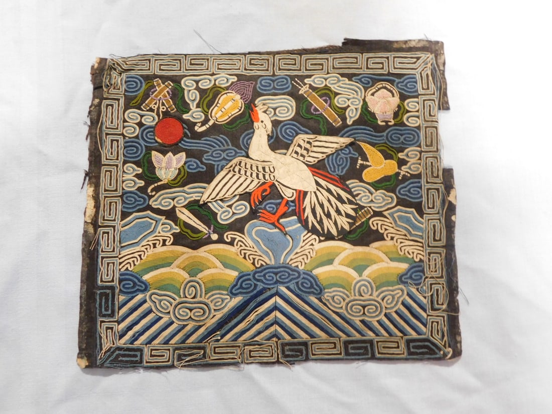 Antique Chinese Rank Badge: Antique Chinese Rank Badge, Qing Dynasty, silk threads on silk, rank 5, Silver Pheasant with varying symbols and key design border, 9 3/4" x 8 3/4". CONDITION: Stitched onto a black cloth backing with