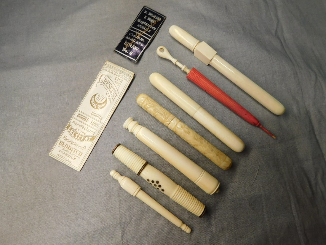 7 Vintage Needle Cases: Seven Vintage Needle Cases in bone and Pachyderm horn, includes: polychromed umbrella with Stanhope depicting South end Pies Essex - L 4 3/4"; one with relief carved fruit and vines 3 3/8"l, the other