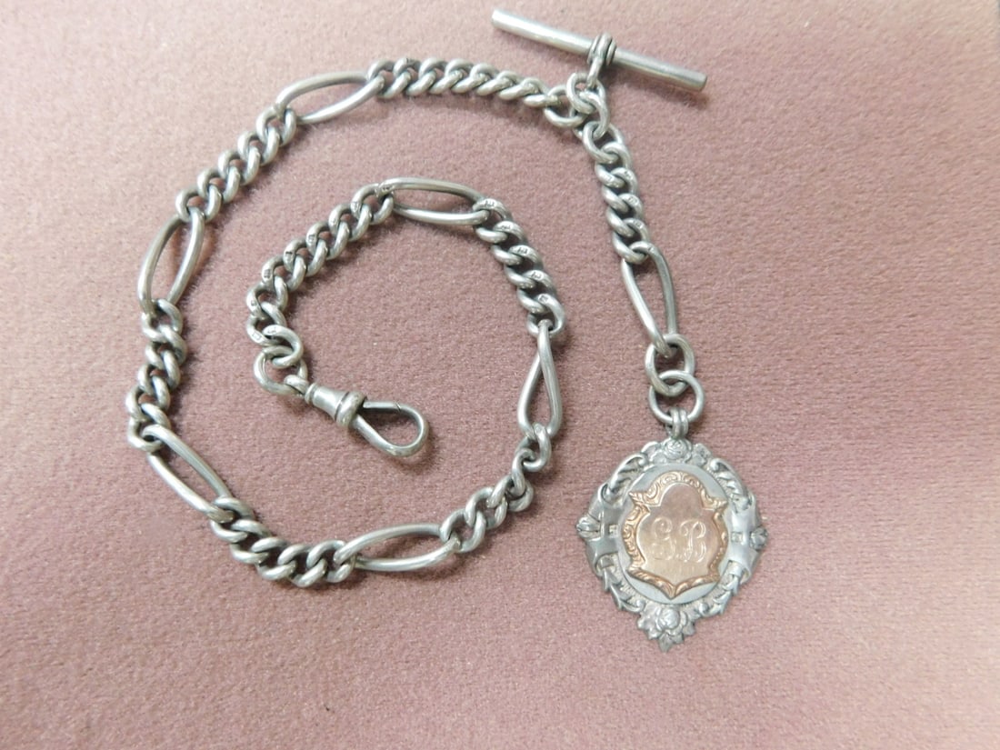 Pocket Watch Chain and Fob: Pocket Watch Chain and Fob, English sterling silver 14? chain with sterling cartouche fob having a gold filled center monogrammed ?GB?, 27.3 DWT. [25] Condition: very good, preowned.