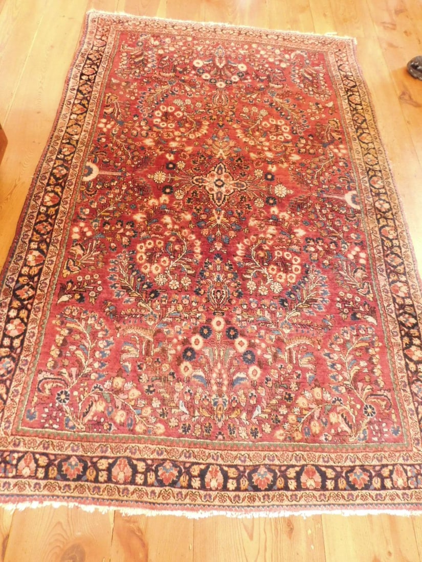 Sarouk area rug: Sarouk area rug in burgundy with overall floral field and boarders, 49" x 78" Condition: minor edge losses