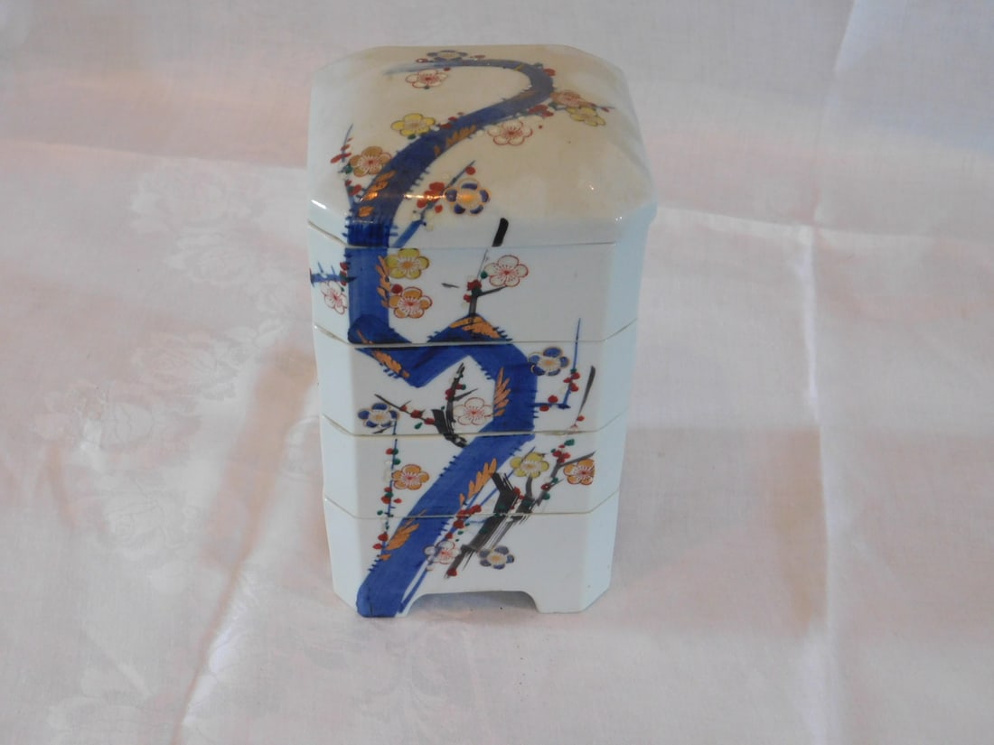 Chinese 5 stack covered jar: Chinese 5 stack covered jar, porcelain with floral motifs, early 20th c. 5 1/2" square, 10" h. Condition: good