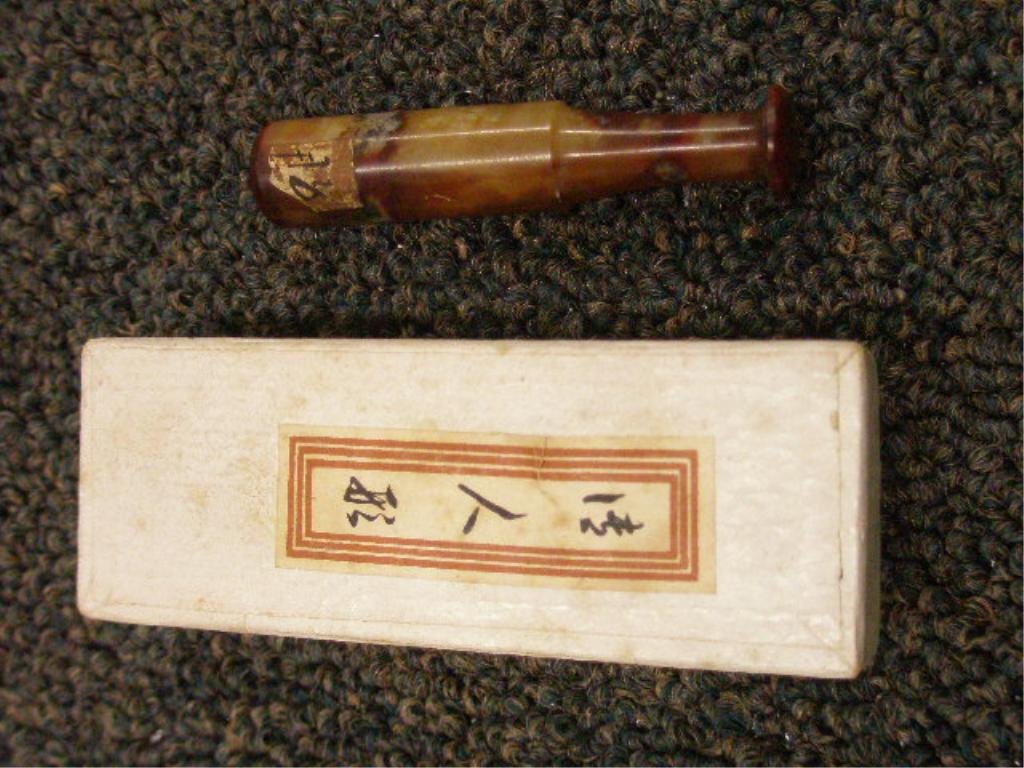 Chinese Cigarette Holder: Chinese carnelian or agate cigarette holder with original paper box with label in Chinese, early 20th C. Condition: No issues identified. Provenance: From the collection of the former Commercial Museu