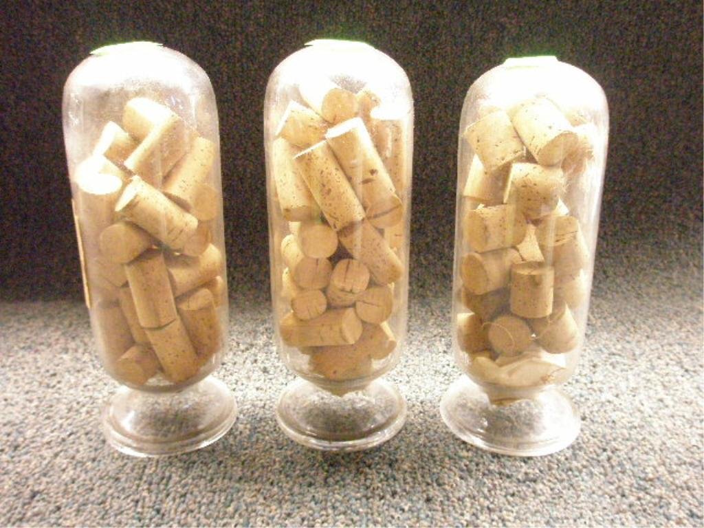 3 Glass Apothecary Bottles: 3 Glass Apothecary Bottles with footed bases, hand blown, containing cork stoppers, 19th C, hgt 9 1/4", condition: no issues identified. Provenance: From the collection of the former Commercial Museum