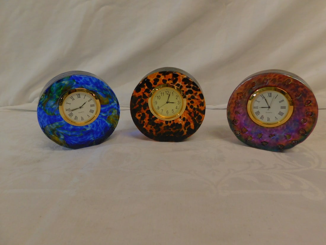 3 Steven Smyers Clocks: Three Steven Smyers Clocks, studio art glass, signed and dated 2009, each with quiet movements, includes: nugget embellished lavender iridescent; cobalt with amber / clear oil slick and a faux tortois