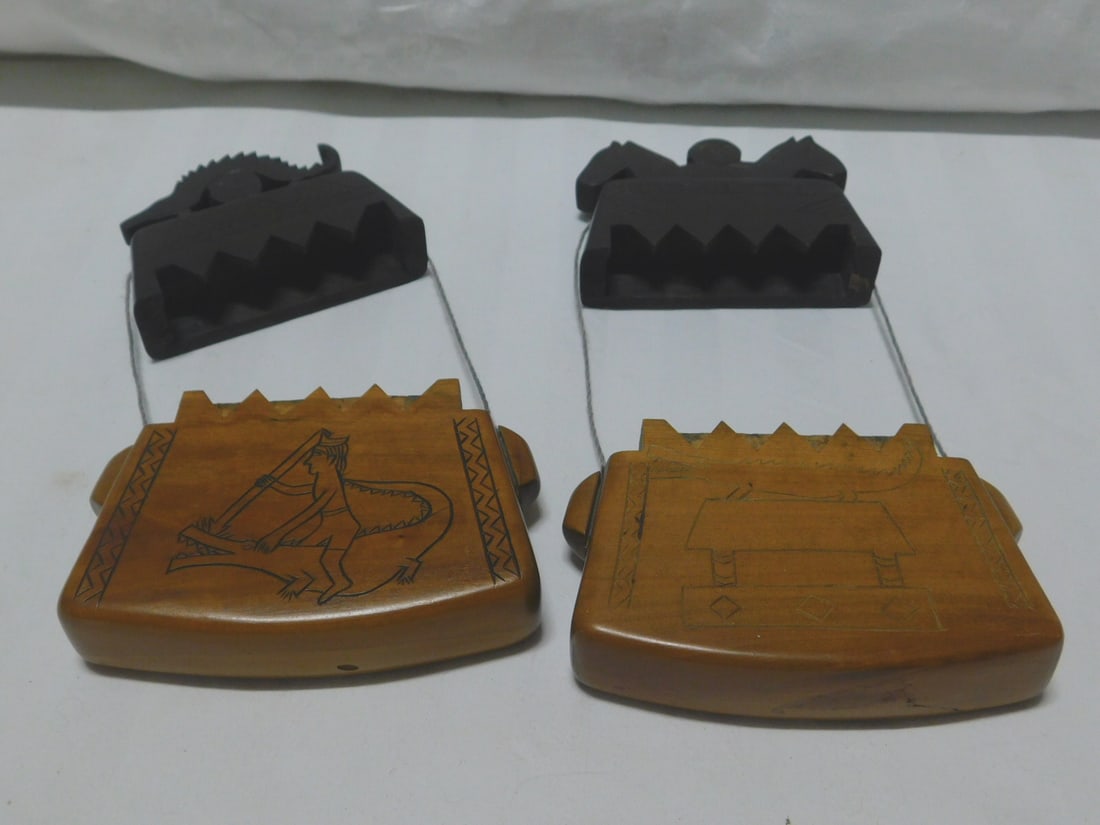 2 Indonesian Purses: 2 Indonesian Purses, Sumba Wood, Tobacco Money Boxes, Tongal tribal, figural lids and engraved bodies, 20th c. 5" x 6" x 1". CONDITION: Very good.