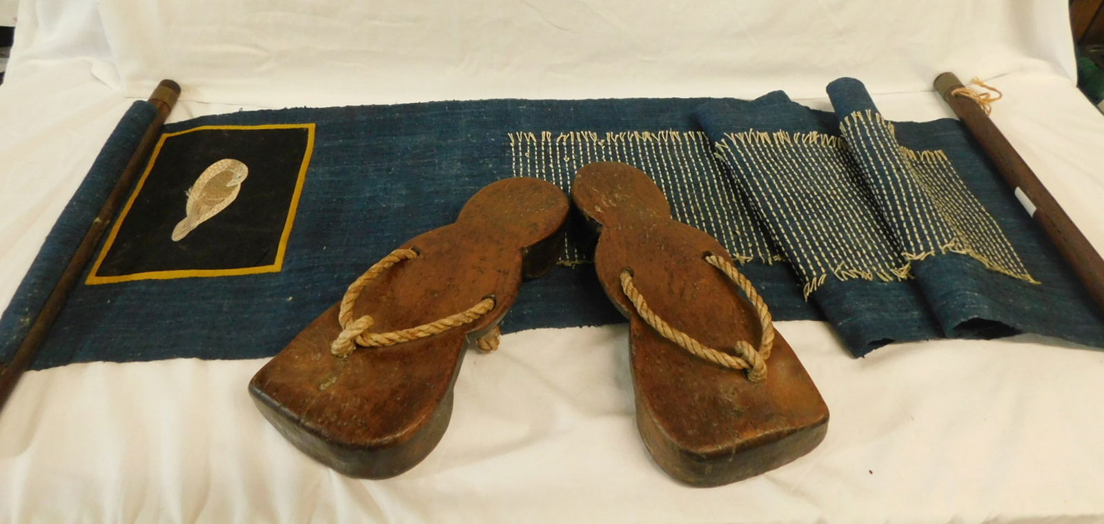 Viet Nam Shoes & Hanging: Viet Nam Shoes and Hanging, vintage carved hardwood sandals with rope with rope,10 3/4"l and a blue cloth scroll with embroidered bird and brass caped rosewood end poles, 16 1/4" x 52". CONDITION: Goo