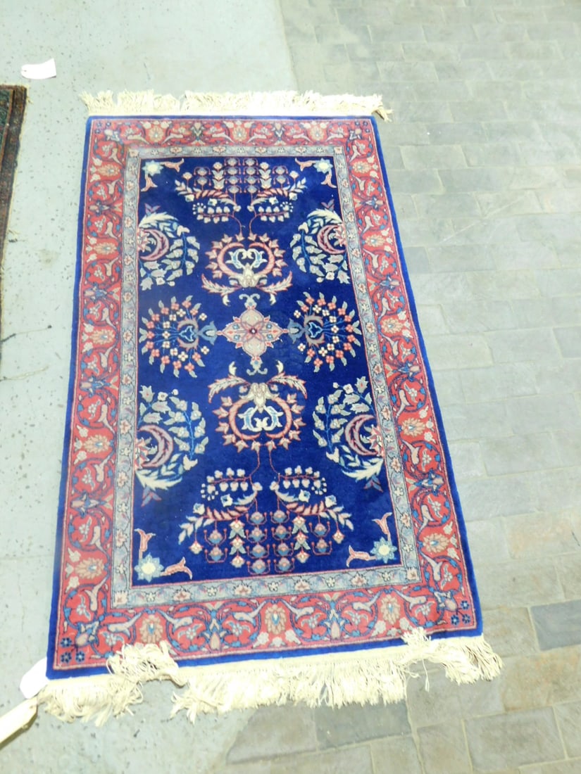 Sarouk Area Rug: Sarouk Area Rug, cobalt ground, burgundy, blues and beiges, medallions, trees and borders, mid to late 20th C, 3' x 5'. [13] CONDITION: Very good.