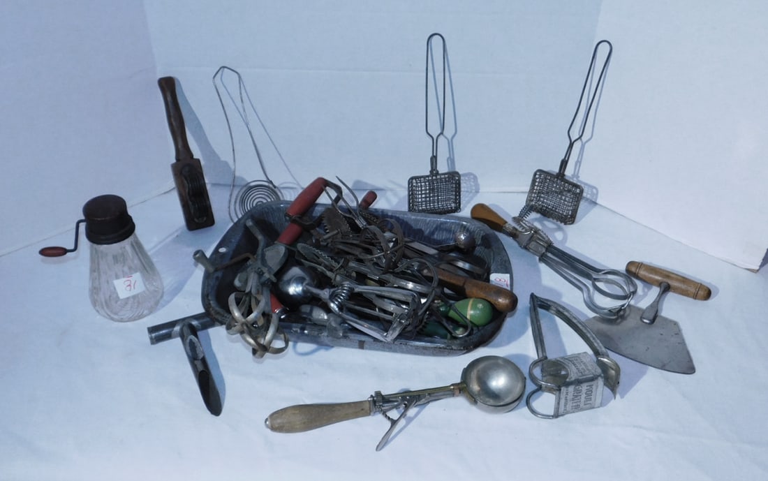 Vintage Kitchen Items: Vintage Kitchen Items, glass bottom grinder, knife sharpener, ice cream scoop, chopper, grader, mixer, carving fork, spoons, forks, etc, agate roasting pan. Condition: used, some with light rust
