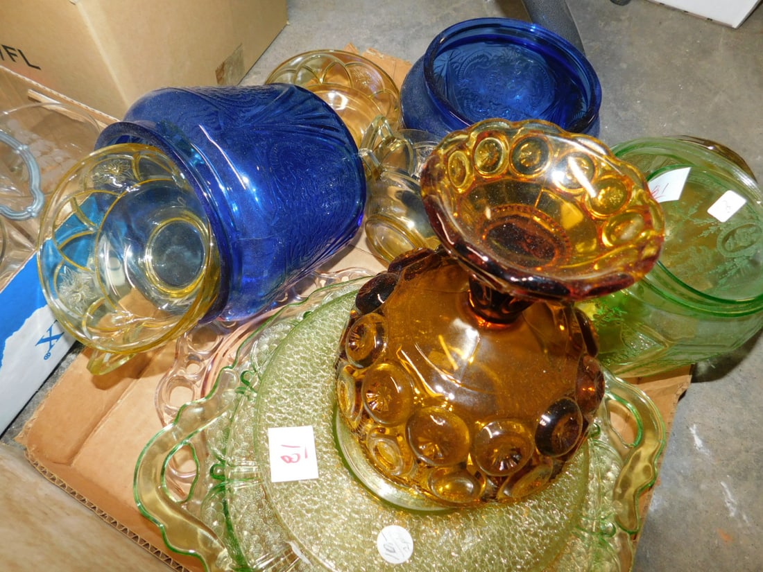 Depression glass lot: Depression glass lot including: multi color, pair amber candle holders, orange juicer, green and onyx glass, amber glass bowls, cups and saucers, cracker jar, compotes, etc. Condition: good