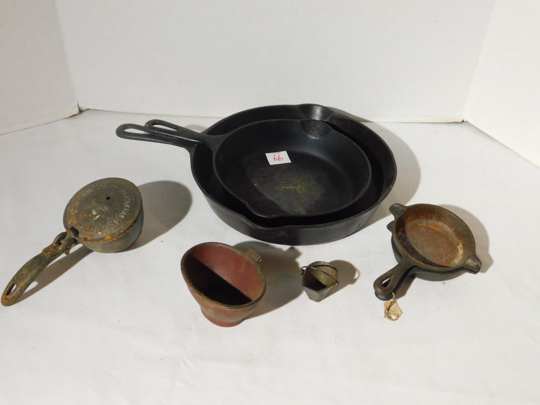 Iron Skillets and other: Iron Skillets and other including: 2 Griswold iron skillets, # 5 and # 8, (2) miniature skillets, Wagner ware 1050D and EMIC 1176 1, plus (2) small miniature melting pots, 1 3/4" and 4", No. 12 ice sh