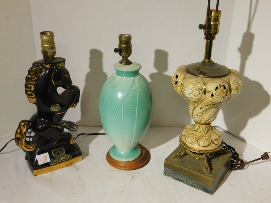 (3) table lamps: (3) table lamps, Howell horse form TV lamp (light in base), 17" (no harp), floral pottery vase lamp, wood base (no harp), 11 3/4", plus floral openwork porcelain lamp with metal base, 17" (measured wi