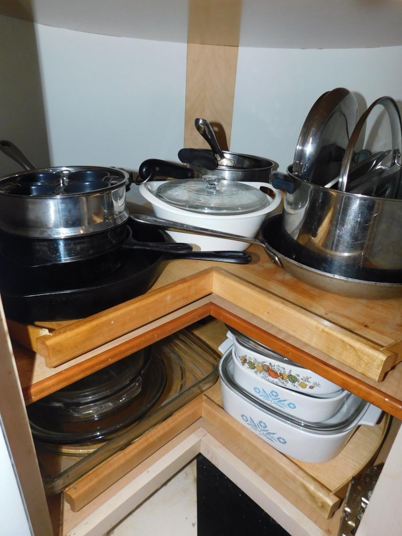 Pots & Pans: Pots & Pans includes 3 graduated corning pots: white enameled iron covered pot, Pyrex & 5 assorted stainless steel pots, Proctor Silex food chopper, 2 iron skillets, etc. CONDITION: Good, used.