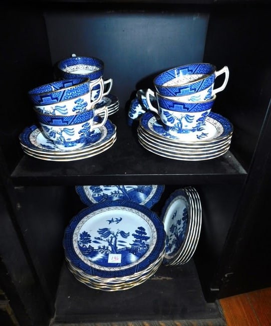 Blue & White Booths China Service: Booths China Service, England, "Real Old Willow" pattern, includes: seven 10 1/2" plates, five 7 3/4" plates, six 6" plates, eight cups and seven saucers. CONDITION: Very good.