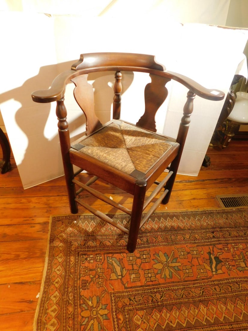 Colonial Style Corner Chair: Colonial Style Corner Chair, mahogany, fiddle back splats, rush slip seat, turned legs and stretchers, 20th C. CONDITION: Loss and cracked rush on seat.