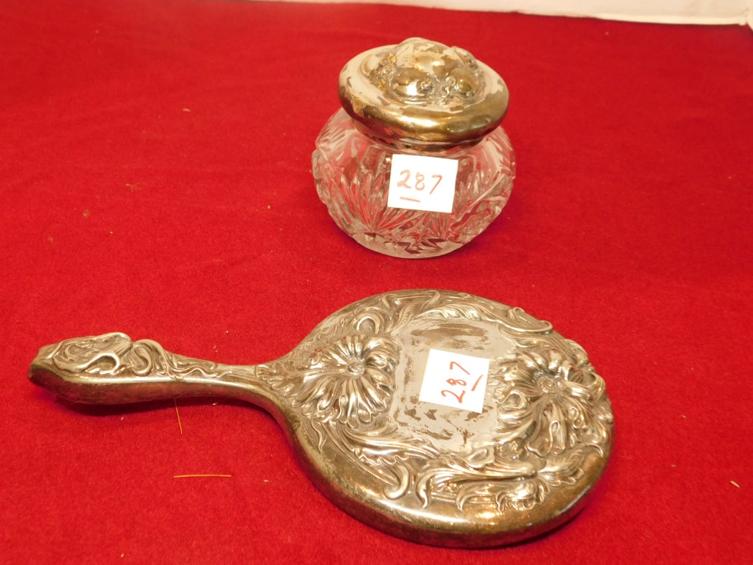 Art Nouveau Mirror & Jar: Art Nouveau Mirror and Jar, silver plate floral and scroll embossing, includes: 10" hand mirror and a molded glass powder jar, circa 1900. CONDITION: Tarnished with some silver finish wear.