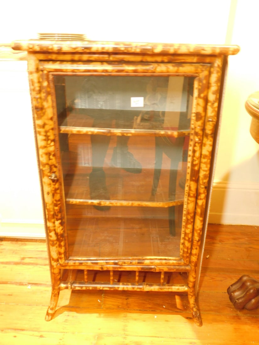 Victorian Curio Stand: Victorian Curio Stand, bamboo construction, beveled smoke glass top, single glass door with two interior shelves, 19th C, 37" x 21 1/2" x 16". CONDITION: No issues identified.