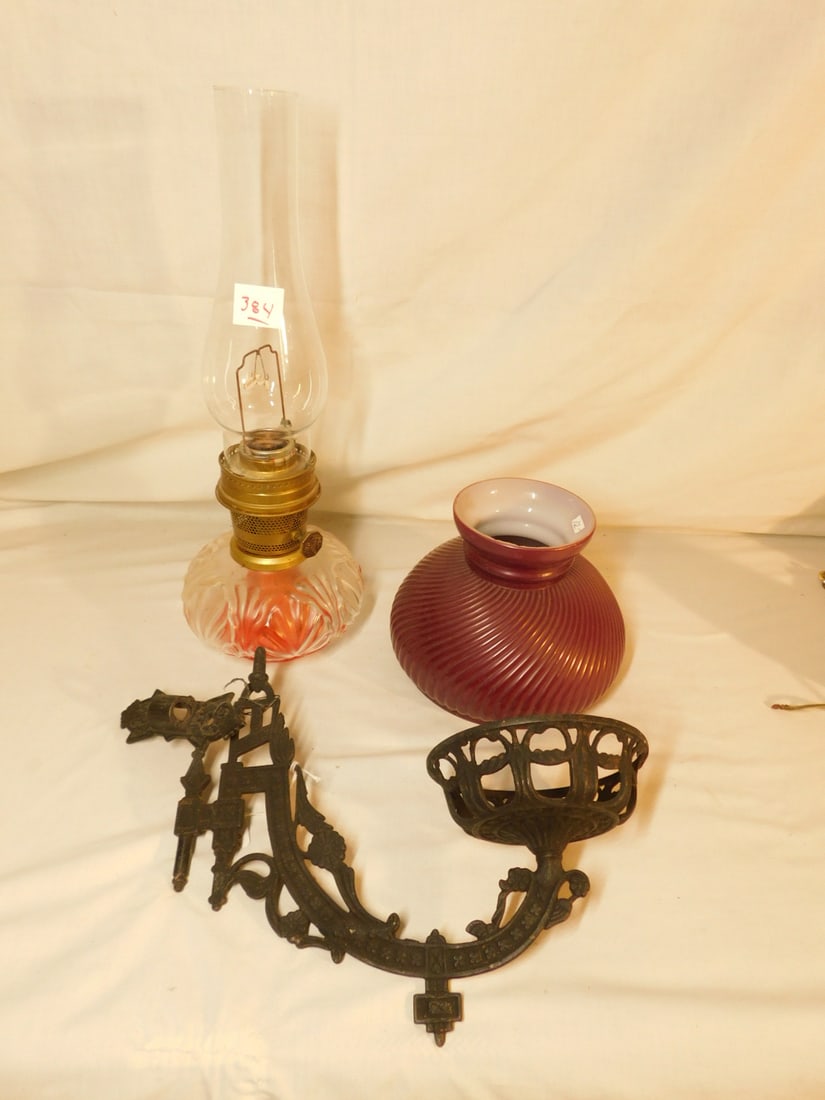Victorian Wall Lamp: Victorian Wall Lamp, Aladdin 23 fluid lamp with clear glass molded fan font; ribbed burgundy cased glass 7"d, shade, chimney and cast iron wall bracket 12"l, late 19th C, CONDITION: Portion of wick, m