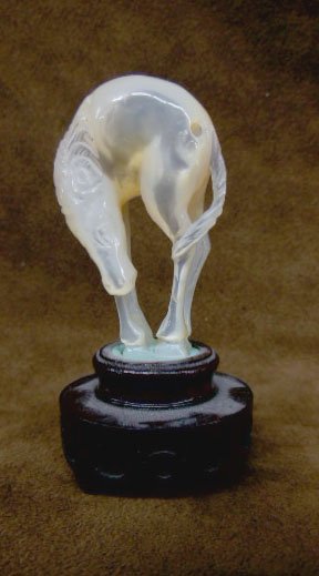 Chinese Mother of Pearl Horse Netsuke: Chinese Mother of Pearl carved Horse Netsuke on wood stand, hgt 2", early 20th c. [17] CONDITION: No issues identified.
