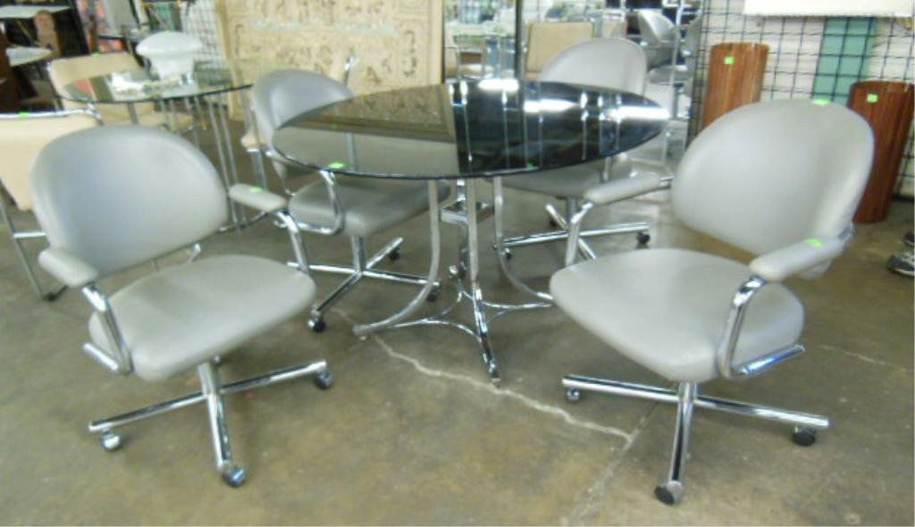 Chromcraft Corp 5 Pc Dinette Set: Chromcroft Corp 5 pc dinette set, tubular chrome construction, 48" diameter smoked plate glass table top, 4 grey vinyl upholstered rolling/ swivel arm chairs, late 20th c. CONDITION: Minor glass scrat