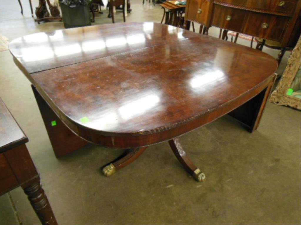Sheraton-style Mahogany Dining Table: Sheraton-style mahogany extension dining table, ovoid reeded edge top, two leaves, carved twin pedestal base, American, mid-20th c. 28"=h; 98 1/2"=w (fully extended); 52"=d. CONDITION: Finish generall
