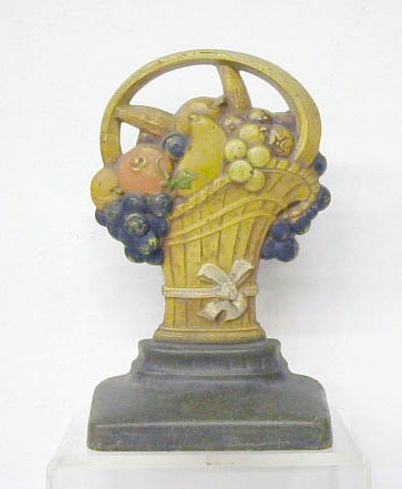 Judd Co. Cast Iron Fruit Basket Doorstop: H.L. Judd Co. painted cast iron #1252 Fruit in French Basket 9 1/2" x 6 1/8" doorstop. CONDITION: Areas with rust & minor wear.