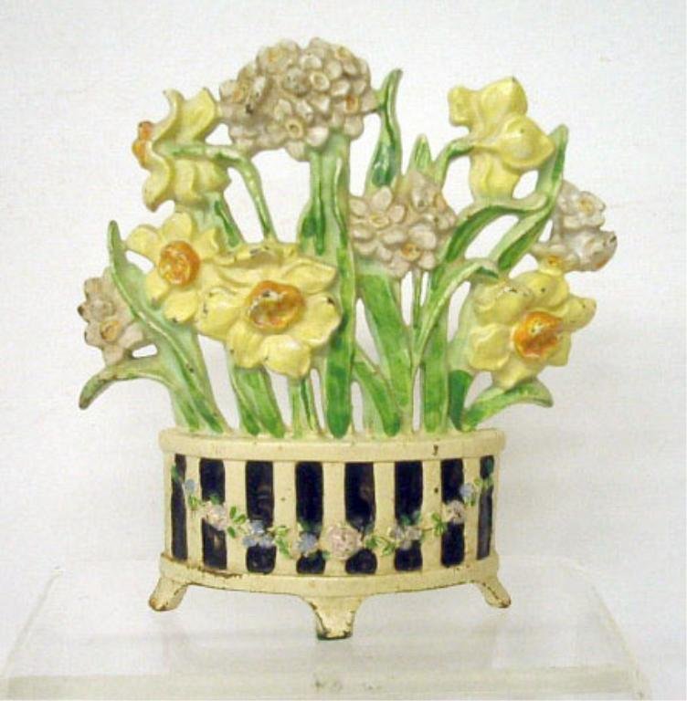 Hubley Cast Iron Narcissus in Pot Doorstop: Hubley Mfg. Co. painted cast iron #266 Narcissus in Three Footed Pot 7 1/2" x 7" doorstop. CONDITION: Areas with paint loss & rust.
