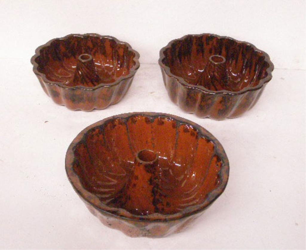 Redware Pottery Turks Head Molds: Three 19th c. redware pottery 3" x 8 1/4", 3 1/2" x 8 1/2" & 3 1/" x 9" Turks Head molds. CONDITION: All have areas with wear, crazing & small chips.