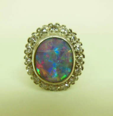 14k, Opal & Diamond Lady's Ring: 14k white gold opal and diamond ring, 11mm x 9mm fiery opal, cracked and scratched, 60+ pts TW diamonds, 3 DWT, size 6 3/4. CONDITION: Vintage worn, opal cracked and scratched.