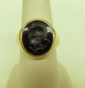 Vintage 14k & Onyx Man's Ring: Vintage 14k yellow gold and onyx man's ring, black intaglio onyx of Roman soldier, 8.5 DWT, size 7 3/4. CONDITION: Vintage, normal wear and scratches on gold.